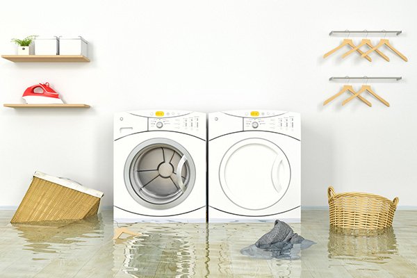 A flooded laundry room in a Tehachapi home needs water damage services.